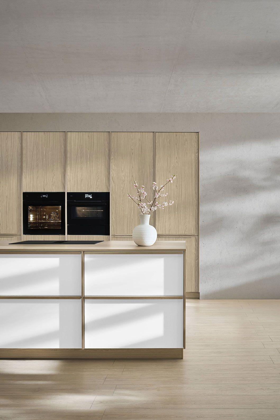 Nobilia Japandi Küche mit heller Holzoptik, weißer Kücheninsel und reduzierter Gestaltung.